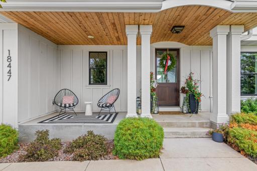A warm & welcoming porch, perfect for morning coffee or reading a book. Rustic wood ceiling brings a cozy vibe.
