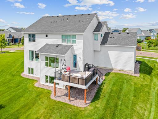 Lush back yard with spacious maintenance free deck