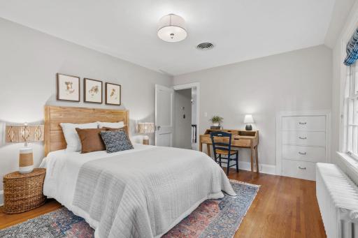 Third bedroom on the second floor with built-in drawers and original hardwood floors