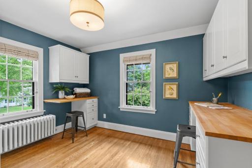 Laundry room/craft room with two desks, cabinetry, and large closet