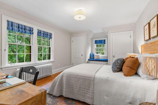 This light-filled room also features two closets and an original window seat with built-in storage