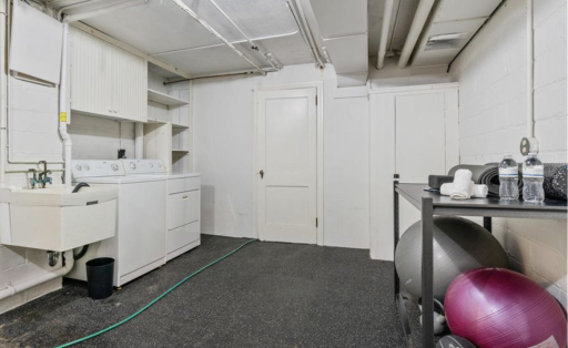 Second laundry area off the gym with washer, dryer and sink