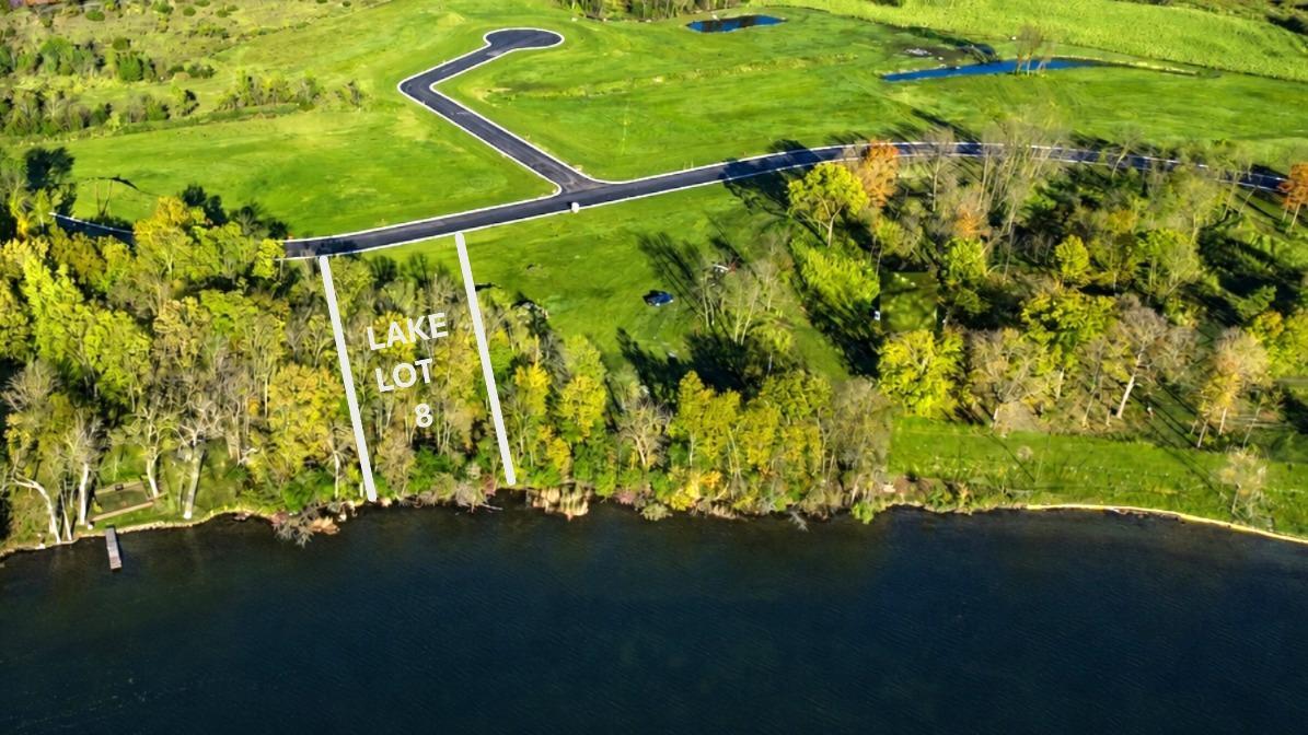 Level lakeshore, panoramic views, and oversized .62 acre level lot with mature trees.