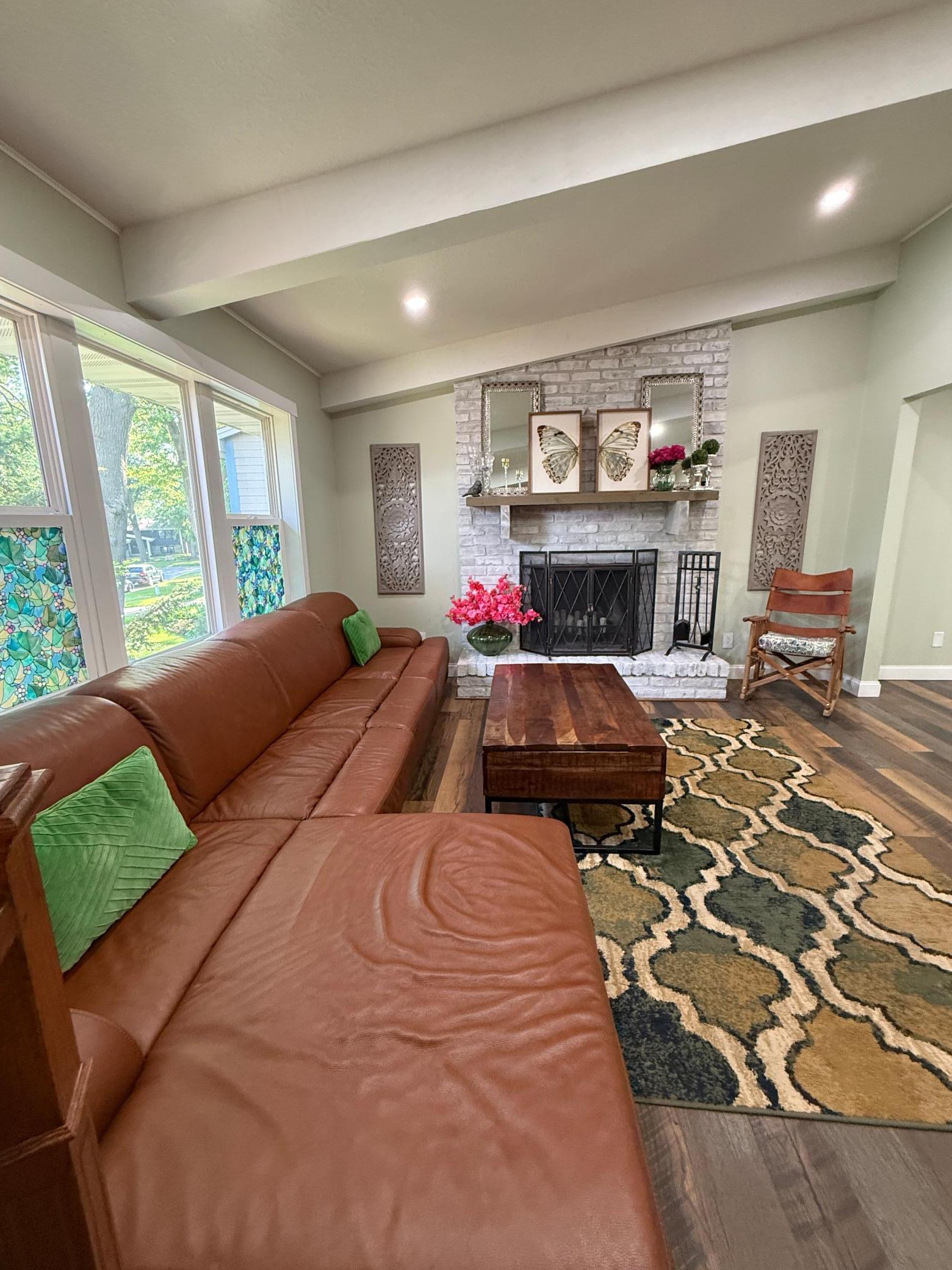 The living room is filled with abundant natural light, creating a bright and welcoming atmosphere.