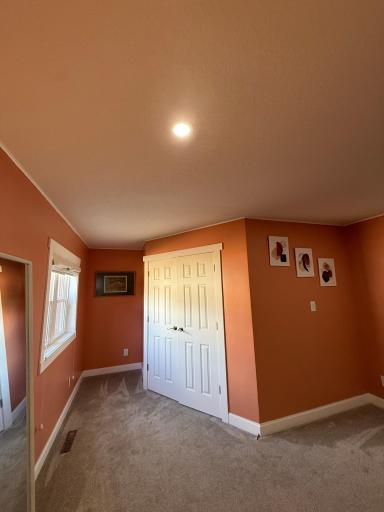 View of the large walk-in closet with built-in shelves and racks.