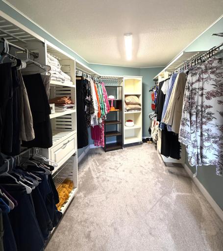 Expansive walk-in closet with built-in shelves.
