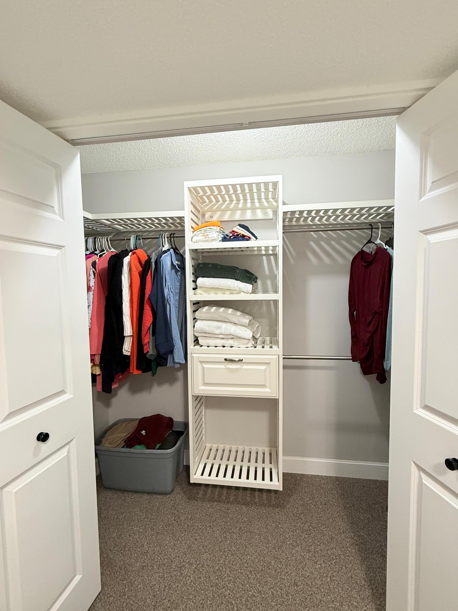 Third bedroom closet with built-ins in the lighted closet.