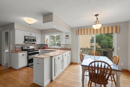 Modern white kitchen and some updated Stainless Steel appliances.