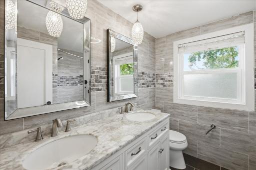 Thoughtfully remodeled bathroom feature stylish updates and modern finishes!