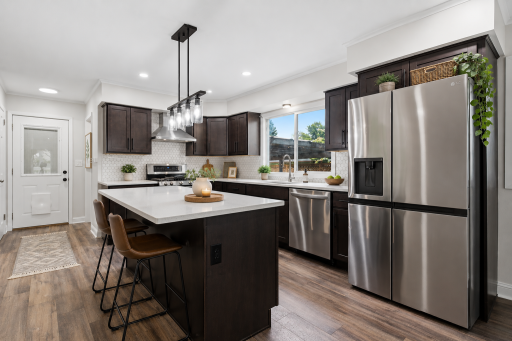 Enjoy this fully remodeled kitchen featuring modern finishes, updated lighting, and newer stainless steel appliances!