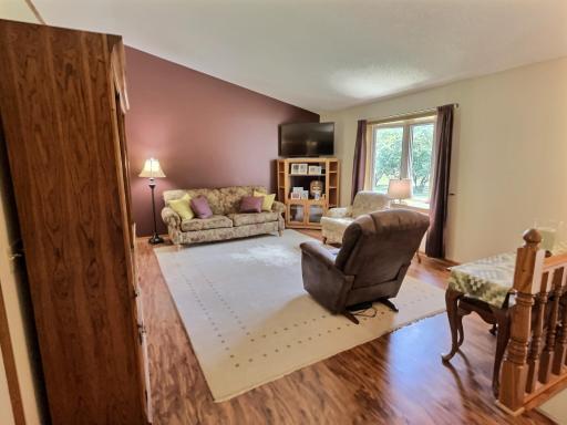 Upper level living room with large bay window.