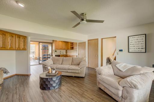 Entertain with ease in the lower-level gathering area featuring beautiful new quartz countertops on the wet bar!