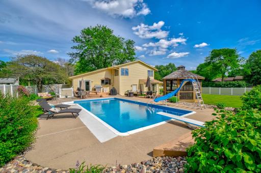 Your private outdoor retreat features a 15' x 30' heated pool with (3') shallow and (8") deep ends, water slide, and diving board!
