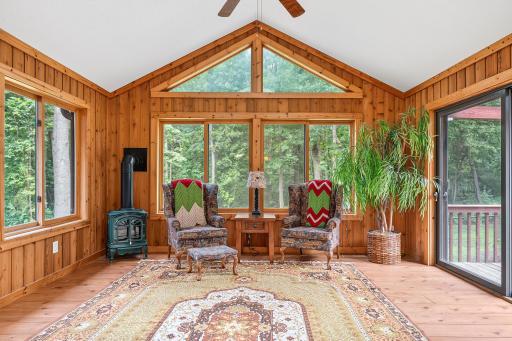 4-season room, wood paneling, wood floors, 2 skylights, sliding door access to the deck, plenty of natural light