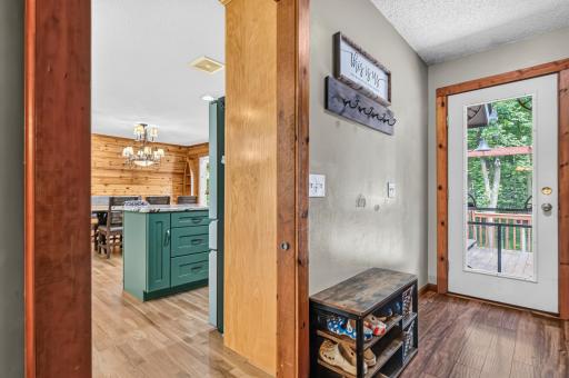 Mudroom with access to back deck, kitchen and basement stairs