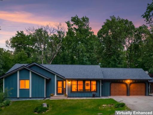 Home and front yard, attached 2-car garage, twilight