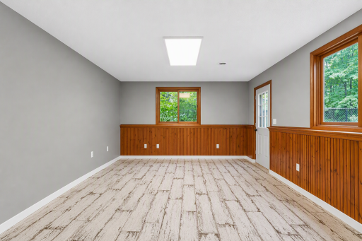 Family room with walkout door - Basement, virtually enhanced