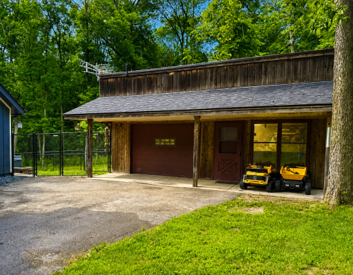 Shop w/LP heat and wood burning stove, 32' x 26', entry doors on front and back side, attached kennel
