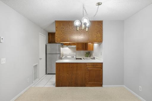 Functional kitchen with ample cabinet space and a breakfast bar for casual dining.
