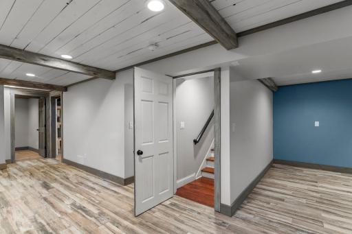 Door opens at the bottom of the stairs to the lower level that has been remodeled and includes LVP flooring and fresh paint and millwork