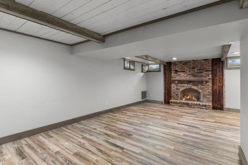 Lower level family room with brick fireplace