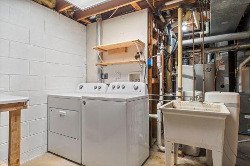 Lower level laundry room with a deep sink