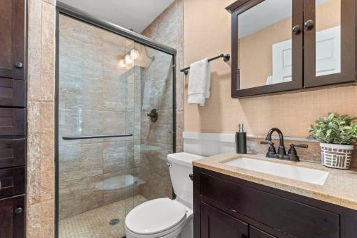 Beautiful 3/4 primary bathroom with tile surround