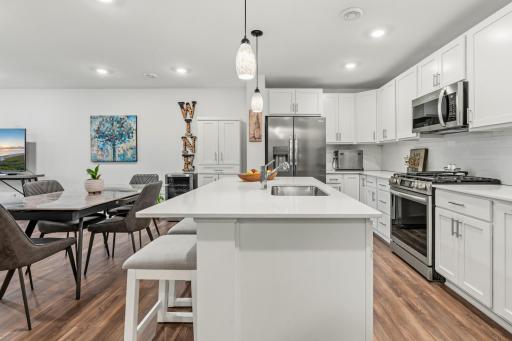 14909 Archdale Lane_The island that does it all â seating, prep space, and storage in one, with stainless appliances.