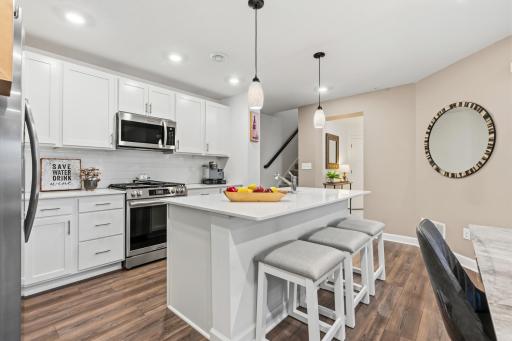 14909 Archdale Lane_White cabinetry, stainless steel appliances, and plenty of counter space.