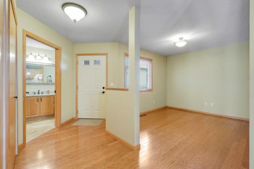 Open wood floored foyer with open parlor or entertainment area. Full bath off entry.