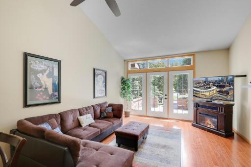 Vaulted rear facing living room with atrium door to patio.