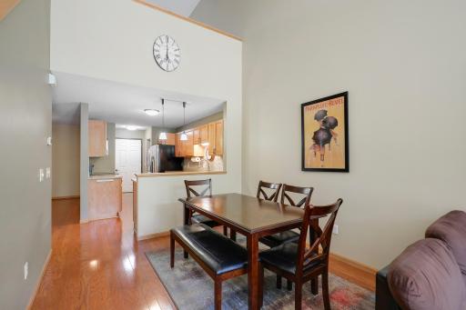 Two story dining area that is opeb to kitchen and living room.
