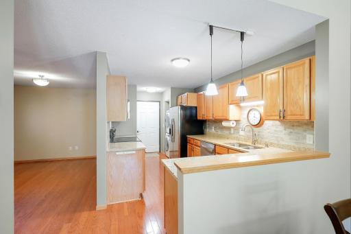 Kitchen opens to garage access and stacked main floor washer & dryer.