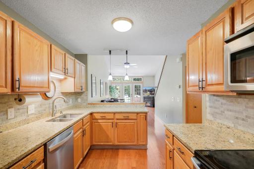 Updated kitchen with solid countertops and ceramic backsplash. Stainless steel appliances.