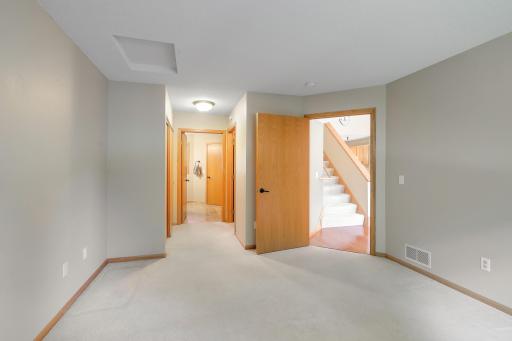 Primary bedroom looking towards walkin closet and sliding doors closet. In the rear the full bath.
