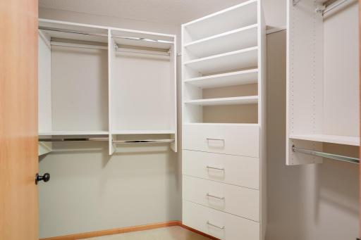 Walkin closet in primary bedroom and adjacent hanging closet.