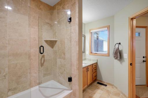 Full bath for primary. Secondary door from foyer for guest use.