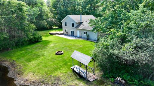 Step across the bridge and walk around the pond near the edges of the property