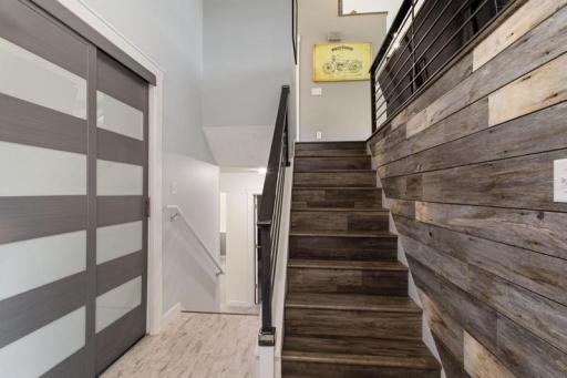 Large entry way complete with modern closet finishes and a beautiful barnwood accent wall