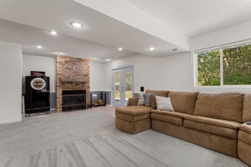 Walk out lower-level family room offers a cozy wood burning fireplace