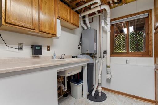 Extremely clean Laundry Room provides tons of counter space & storage