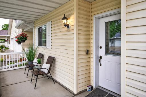The welcoming front porch is sheltered from the rain and sun. It's the perfect place to say hello to the neighbors on their way to the walking path