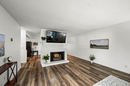 A cozy wood-burning fireplace with its freshly painted surround adds warmth and charm year-round.