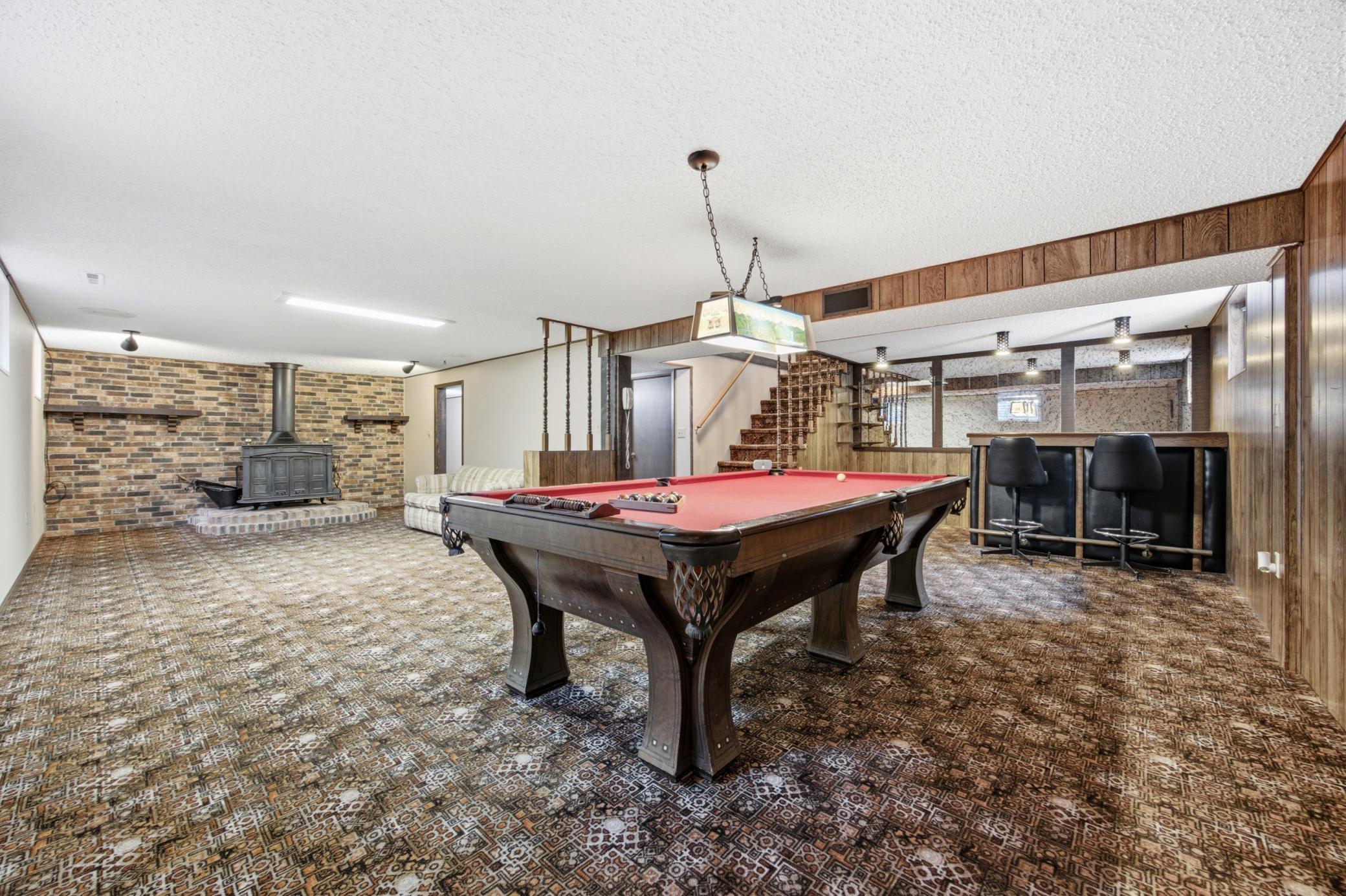 Large family room w/wet bar, pool table and wood burning fireplace