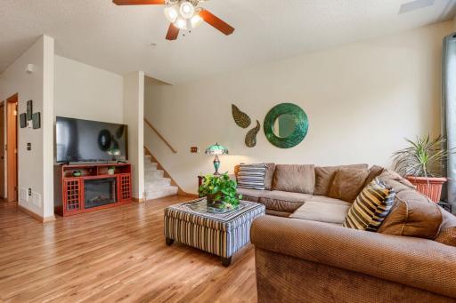 Step into a bright and inviting living room featuring beautiful floors, expansive windows that fill the space with natural light, and a seamless open-concept layout. The flowing floor plan connects the living room to the dining area and kitchen.