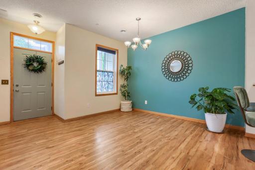 The spacious dining area is filled with natural light from a large window, creating a bright and inviting setting for everyday meals and special occasions. With ample room for entertaining, the open, floor plan enhances the home's welcoming feel.