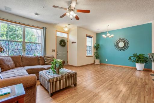 The and dining rooms offer a bright, open atmosphere enhanced by beautiful floors and abundant natural light. Expansive windows create an inviting setting, while the seamless layout provides an ideal space for both everyday living and entertaining.