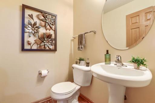 Conveniently located nearby, the stylish half bath provides added comfort and practicality for guests.