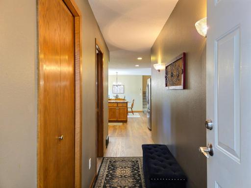 Hallway leading from the garage features coat closet and 1/2 bath
