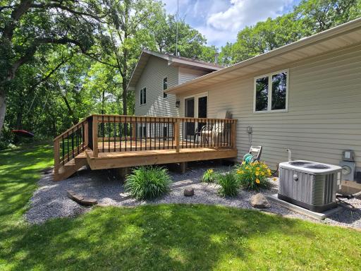 Beautiful landscaping continues to the back of the home and surrounds the deck